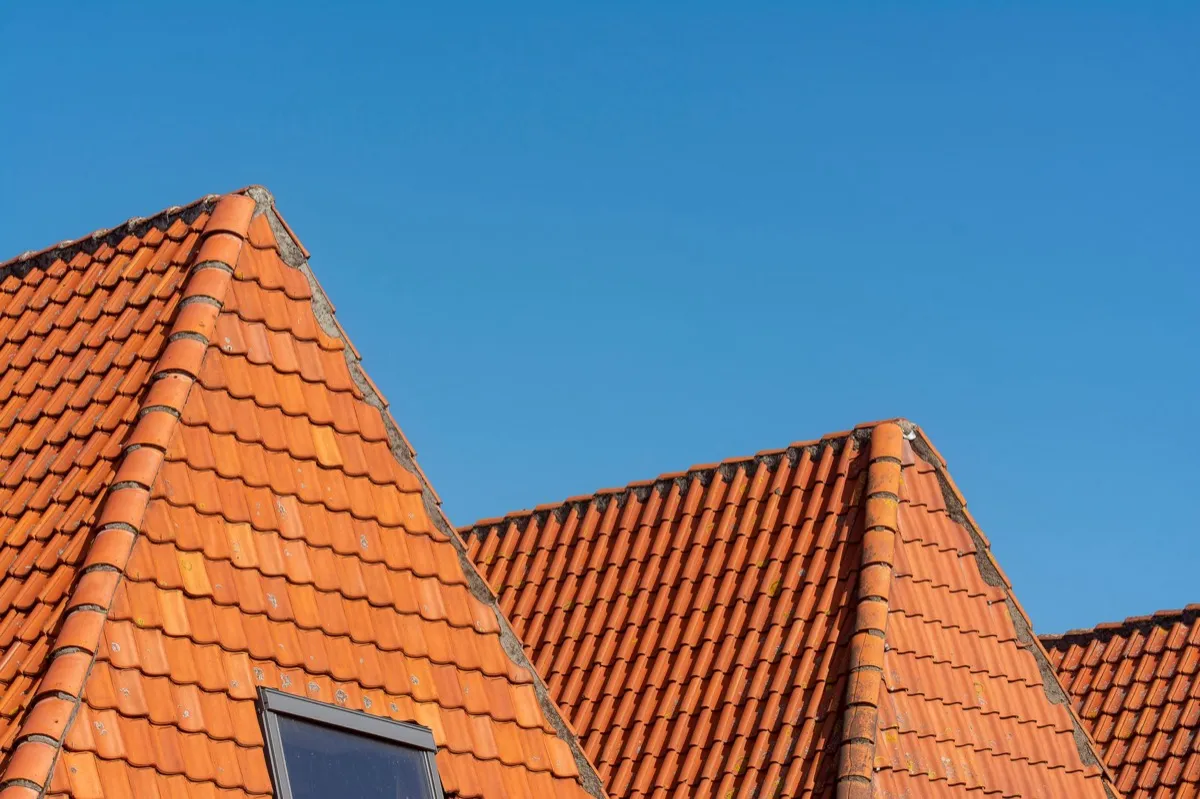 Clay barrel tile rooflines on homes in Brentwood, NY